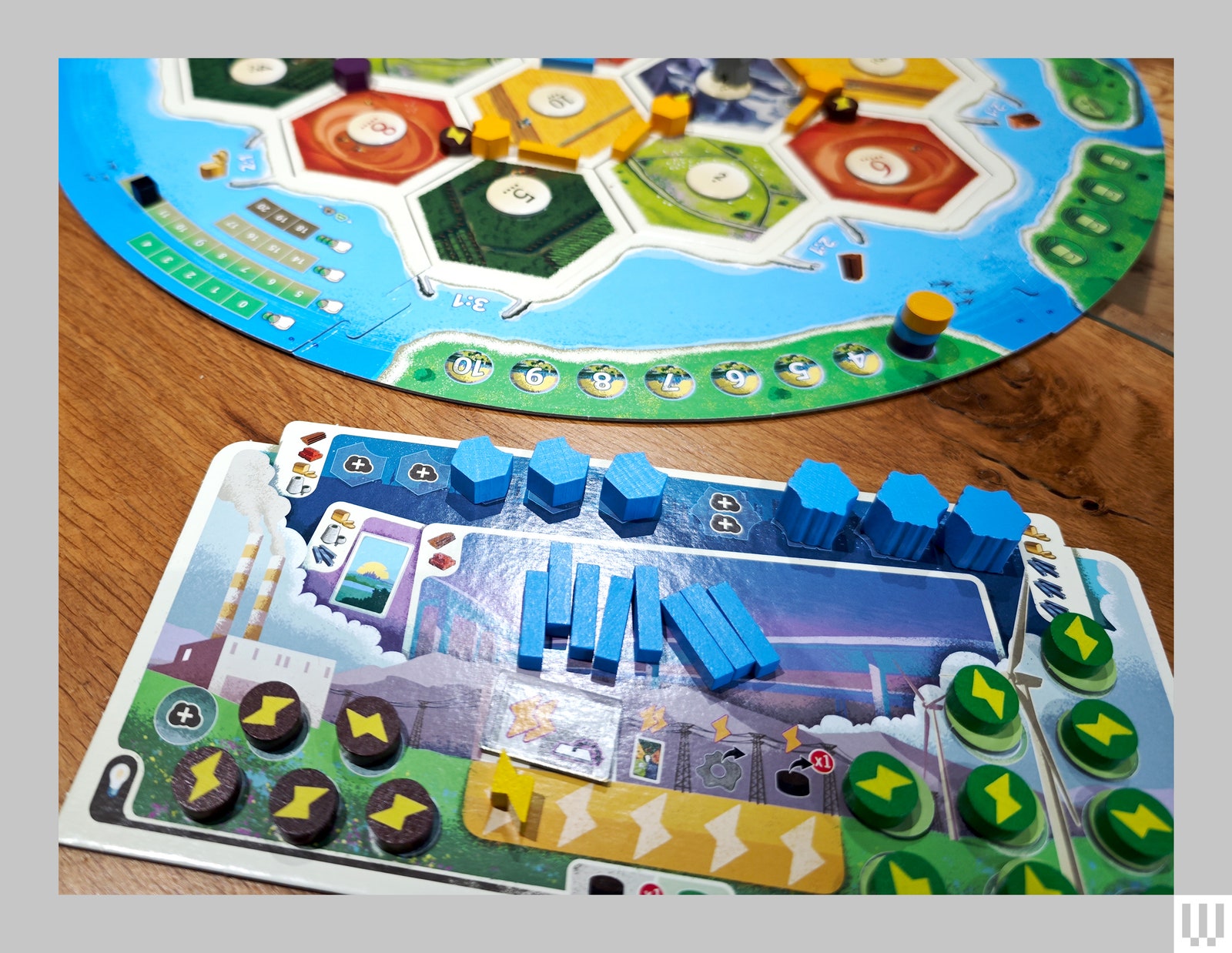 Closeup of boardgame player card including stackable pieces